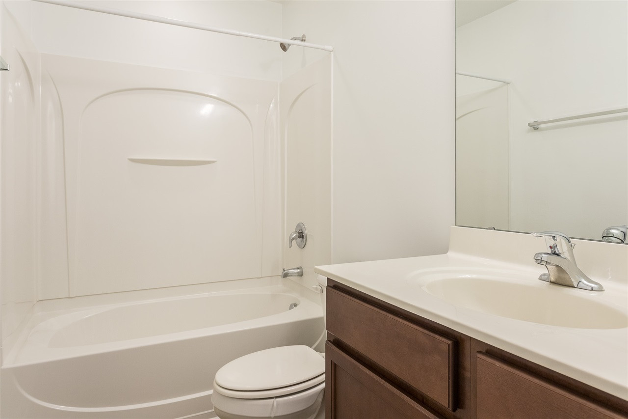 9929 Lynnberry Place Raleigh, NC 27617 - Photo 26 of 30 The upstairs hall bath is conveniently located near the secondary bedrooms and features a tub/shower combination with chrome fixtures, a single sink with chrome faucet, and stained cabinets with brushed nickel hardware. Upstairs Hall Bath