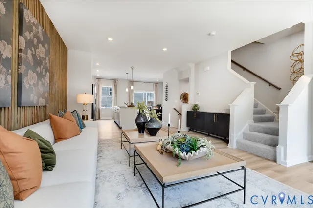 a living room with furniture potted plant and a painting on the wall