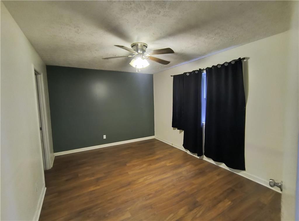 89 Murray Springs Road Chatsworth, GA 30705 - Photo 10 of 14 an empty room with closet and a ceiling fan
