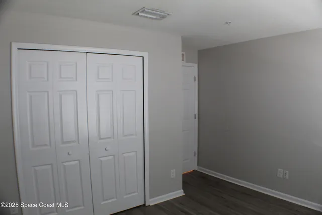 an empty room with wooden floor