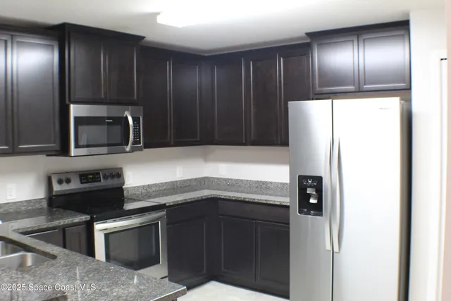 a kitchen with a refrigerator and a sink