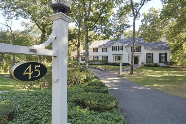 45 Falmouth Road Wellesley, MA 02481 - Photo 1 of 27 a view of a house with a small yard and large trees