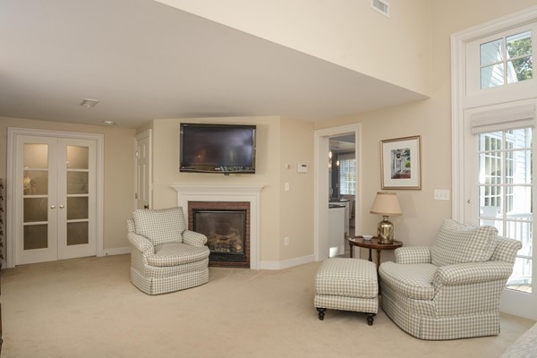 45 Falmouth Road Wellesley, MA 02481 - Photo 12 of 27 a living room with furniture a fireplace and a flat screen tv
