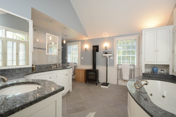 45 Falmouth Road Wellesley, MA 02481 - Photo 14 of 27 a bathroom with a granite countertop tub sink and mirror