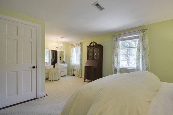 45 Falmouth Road Wellesley, MA 02481 - Photo 15 of 27 a bedroom with a bed and a television