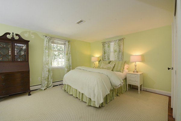 45 Falmouth Road Wellesley, MA 02481 - Photo 16 of 27 a spacious bedroom with a bed and a window