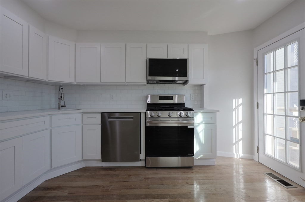 3 Appian Place Boston, MA 02128 - Photo 1 of 15 a kitchen with stainless steel appliances a stove a microwave and sink