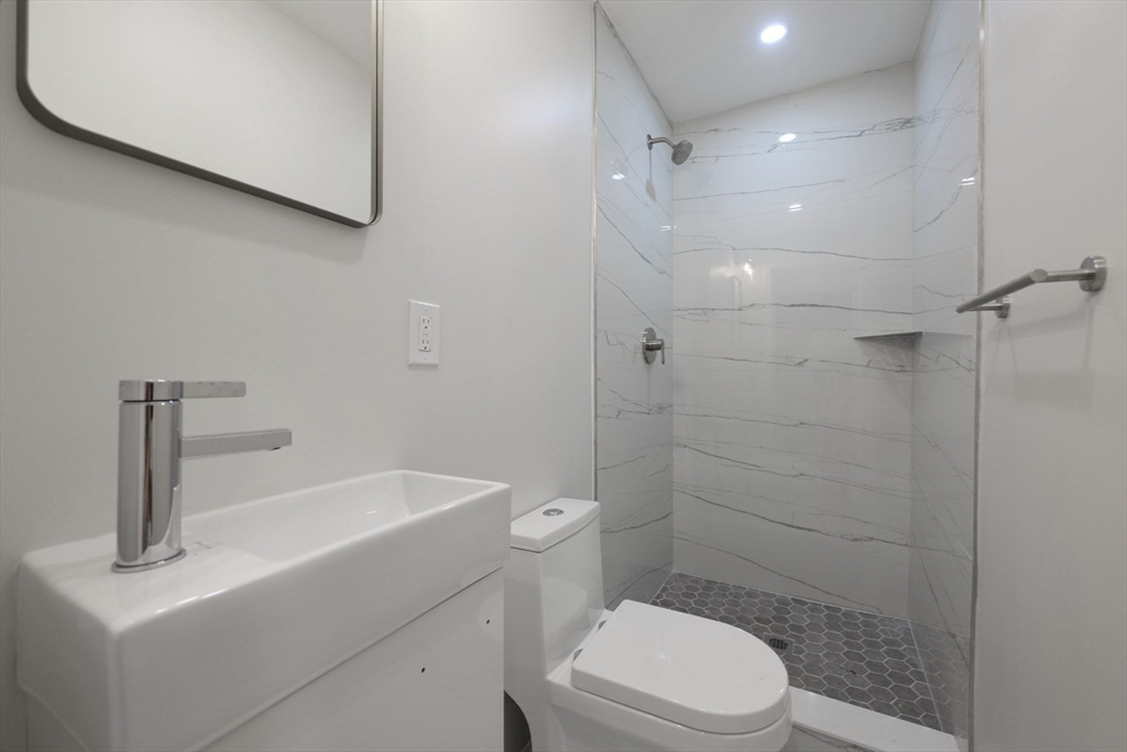 3 Appian Place Boston, MA 02128 - Photo 11 of 15 a bathroom with a sink a toilet and shower