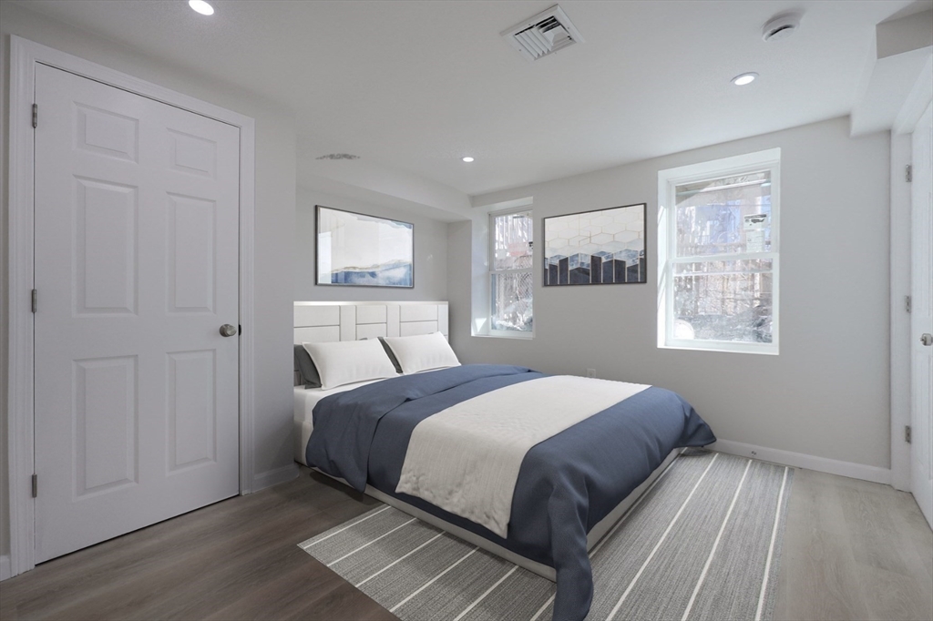 3 Appian Place Boston, MA 02128 - Photo 7 of 15 a bedroom with a bed and wooden floor