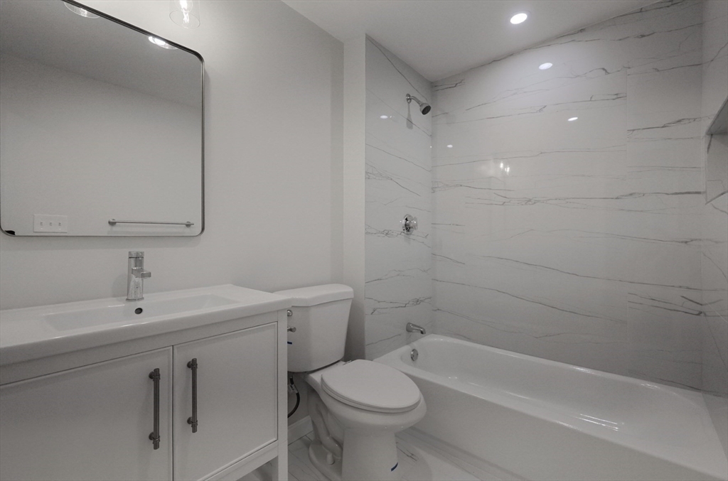 3 Appian Place Boston, MA 02128 - Photo 8 of 15 a bathroom with a sink toilet vanity and bathtub