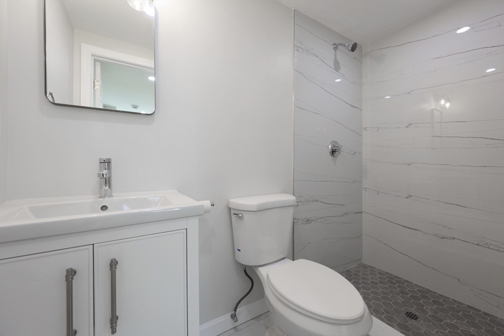 3 Appian Place Boston, MA 02128 - Photo 10 of 15 a white toilet sitting next to a bathroom sink