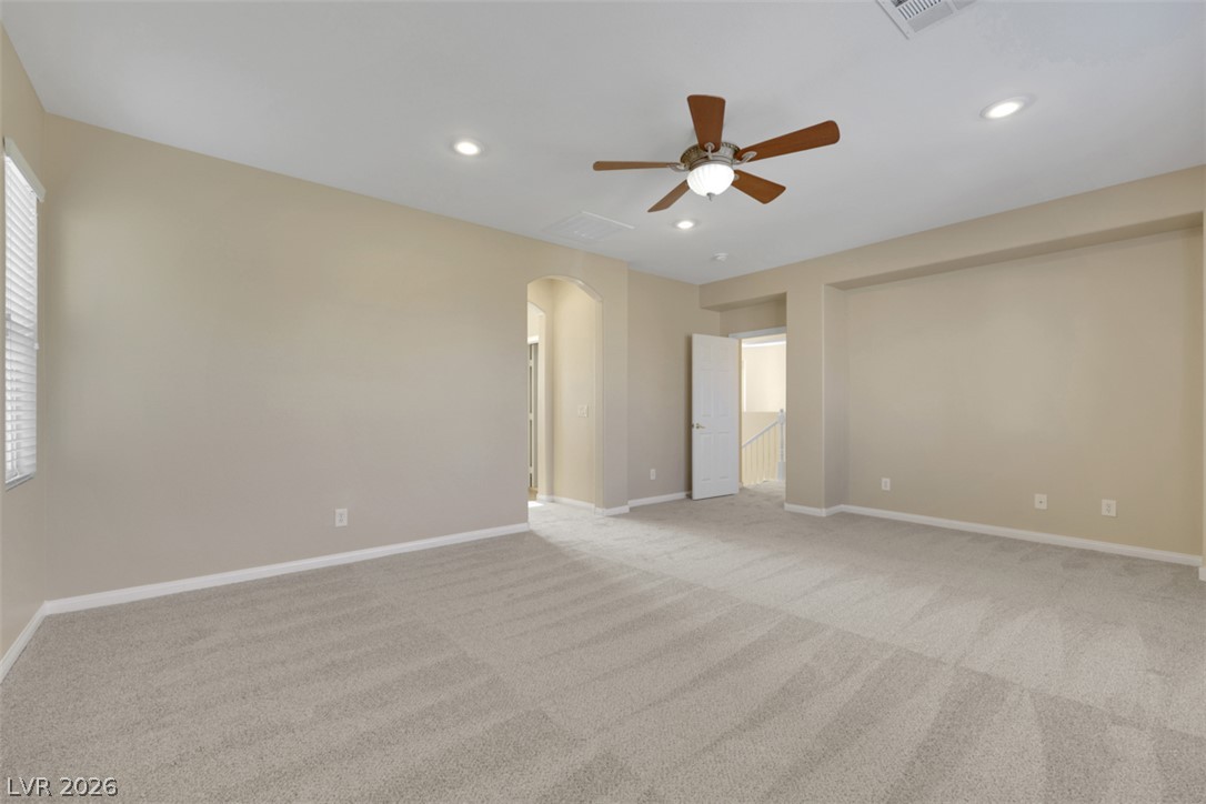 10328 Hawk Ravine Street Las Vegas, NV 89178 - Photo 39 of 55 A spacious room offers comfortable carpet flooring, recessed lighting, and a ceiling fan for year-round comfort.
