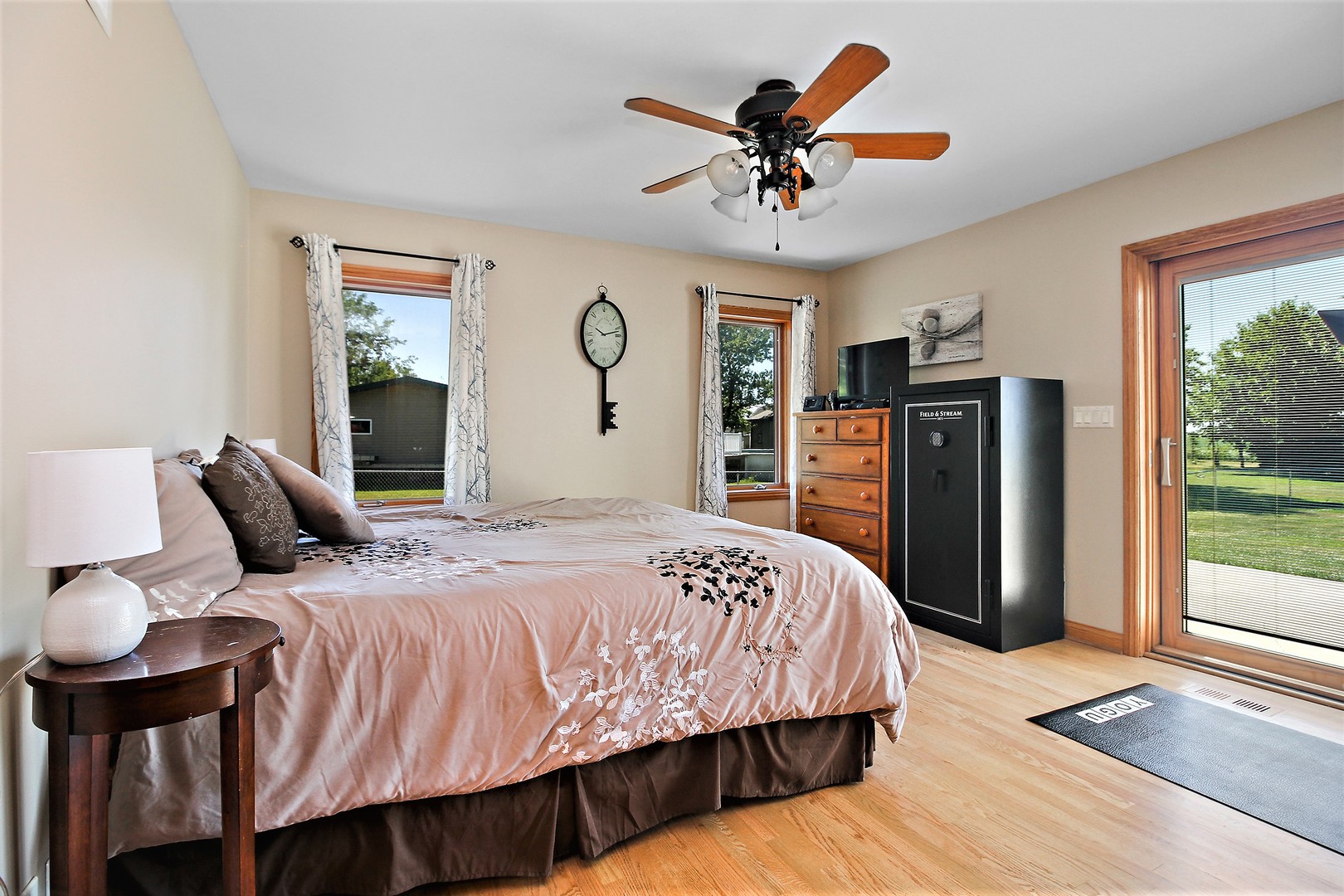 2068 East 7750S Road Chebanse, IL 60922 - Photo 11 of 24 a bedroom with a bed a dresser and a large window