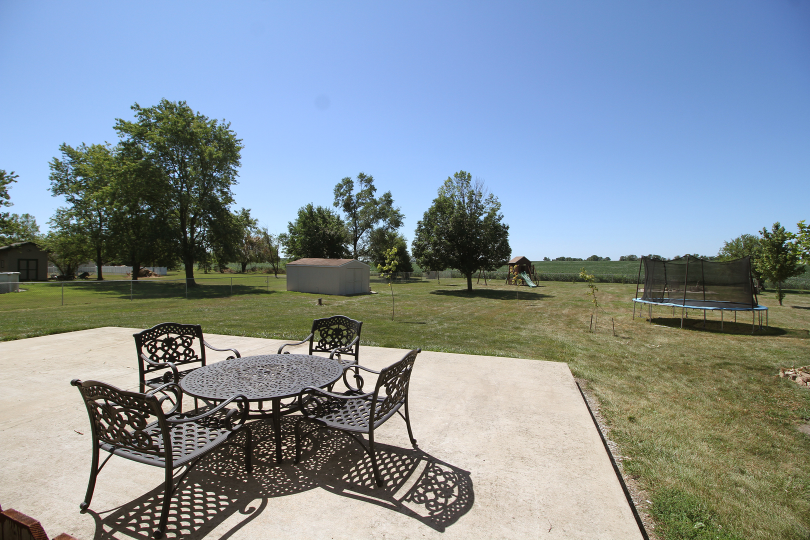 2068 East 7750S Road Chebanse, IL 60922 - Photo 21 of 24 a view of a lake with table and chairs under an umbrella