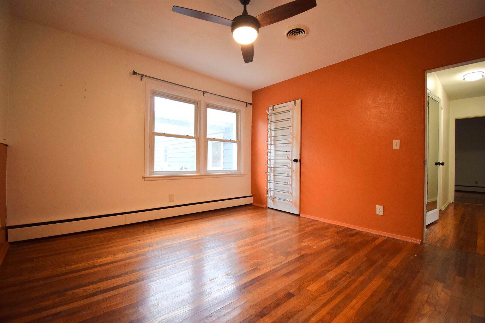 3109 Peach Street Mount Vernon, IL 62864 - Photo 12 of 29 an empty room with wooden floor chandelier fan and windows