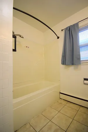 a bathroom with a shower and a shower