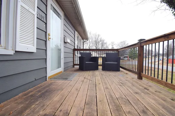 a balcony with wooden floor