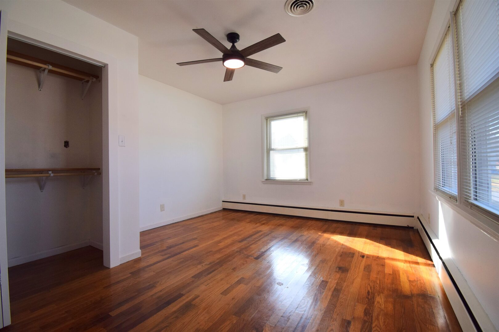 3109 Peach Street Mount Vernon, IL 62864 - Photo 8 of 29 an empty room with wooden floor fan and windows