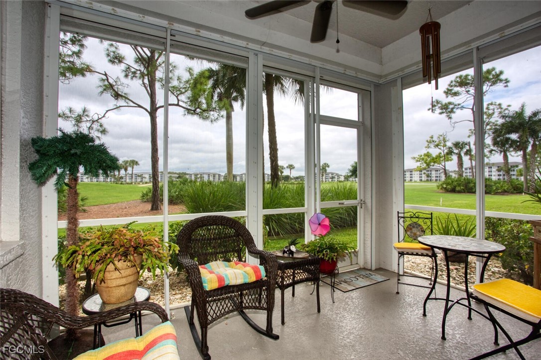 8076 Queen Palm Lane, Unit 416 Fort Myers, FL 33966 - Photo 16 of 18 a view of a porch with chairs and a yard