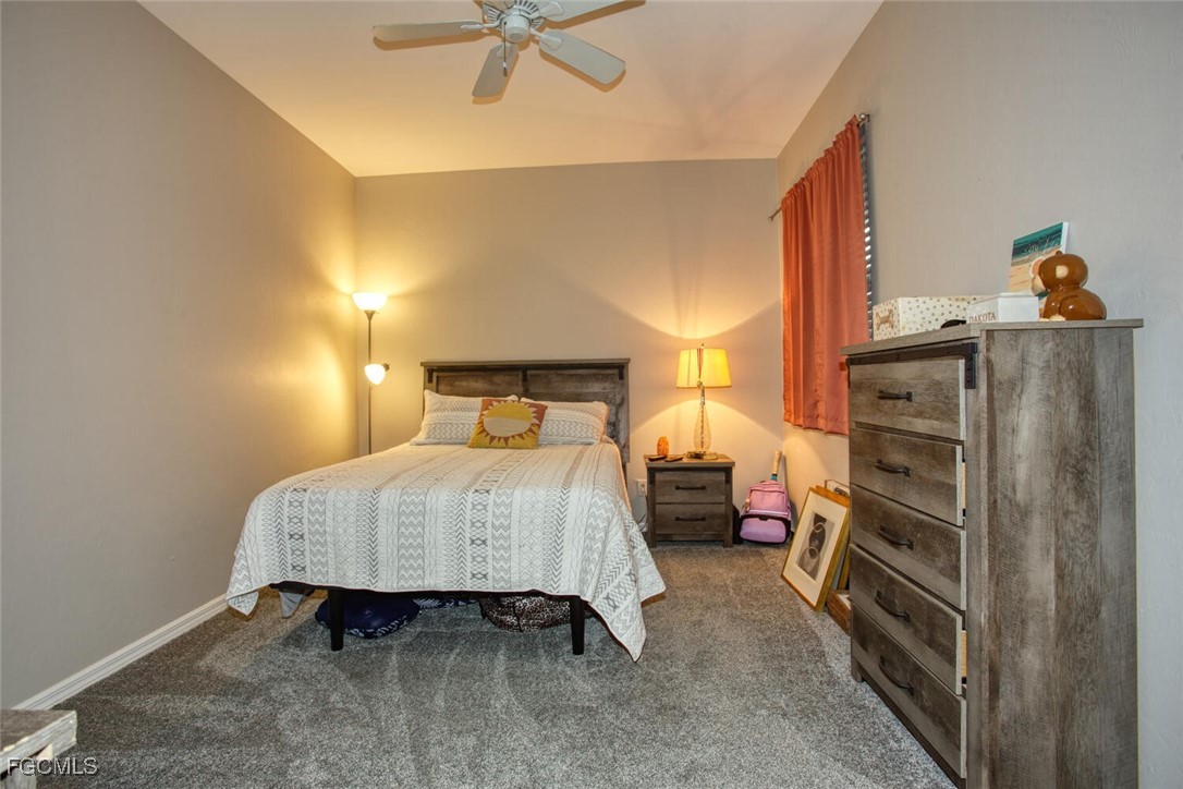 8076 Queen Palm Lane, Unit 416 Fort Myers, FL 33966 - Photo 18 of 18 a bedroom with a bed and a chandelier