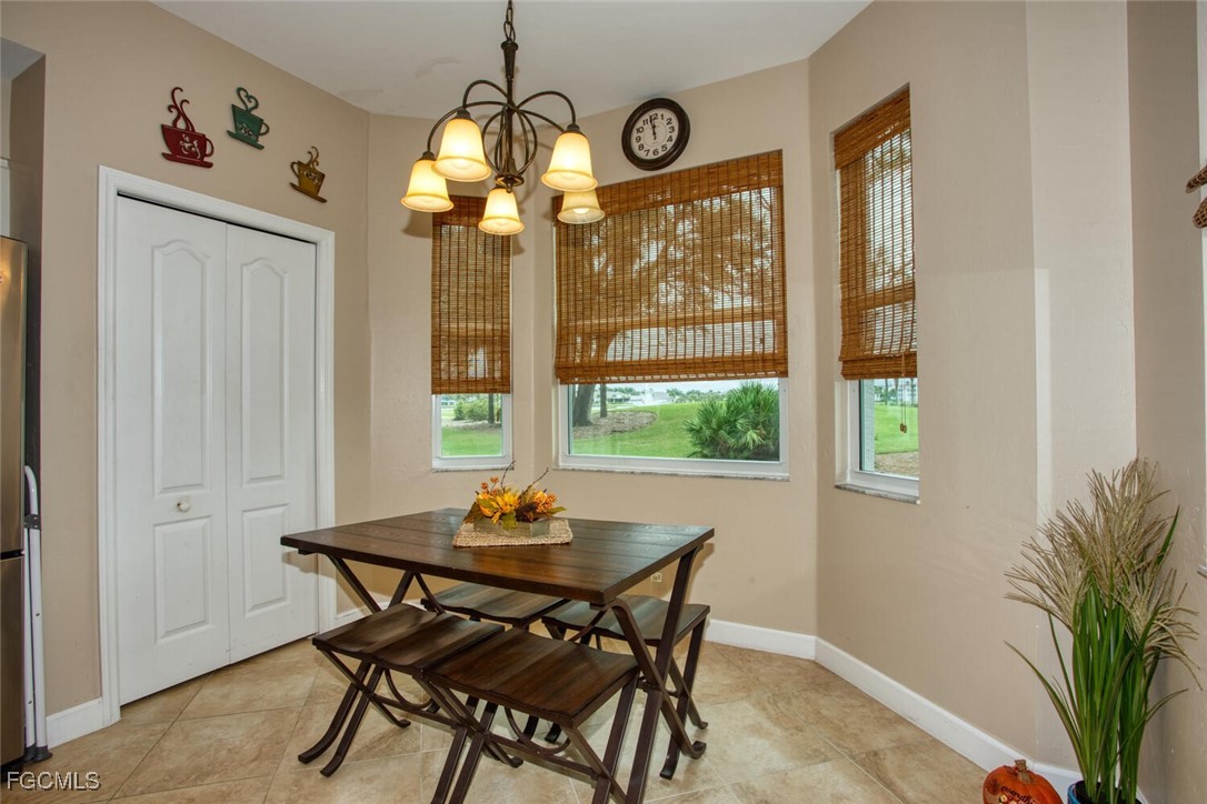 8076 Queen Palm Lane, Unit 416 Fort Myers, FL 33966 - Photo 2 of 18 a view of a dining room with furniture window and outside view