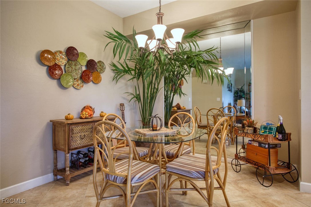 8076 Queen Palm Lane, Unit 416 Fort Myers, FL 33966 - Photo 8 of 18 a view of a dining room with furniture and a potted plant