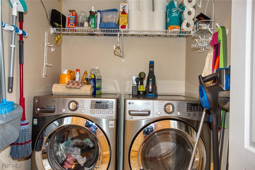 8076 Queen Palm Lane, Unit 416 Fort Myers, FL 33966 - Photo 9 of 18 a utility room with dryer and washer