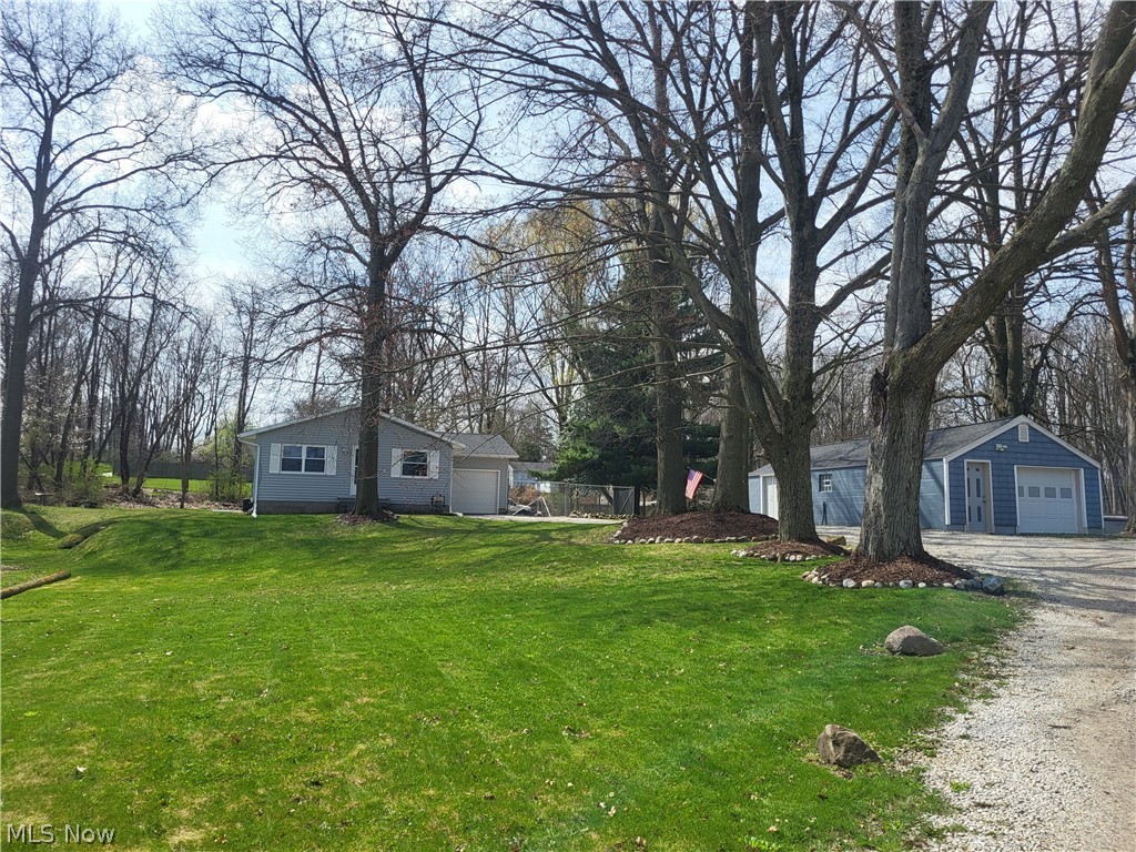 View of yard with an outdoor structure and a garage