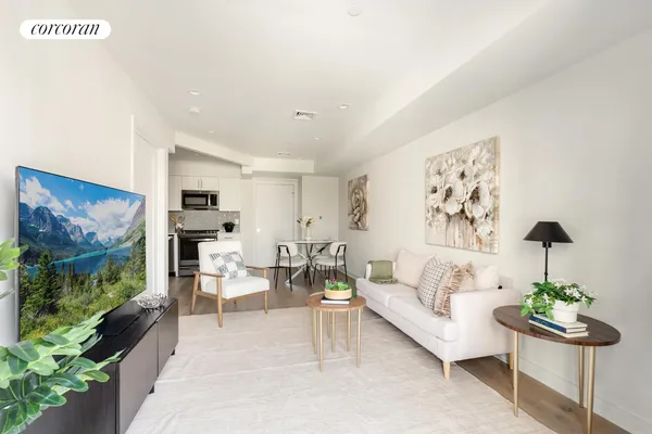 a living room with furniture and a painting on the wall