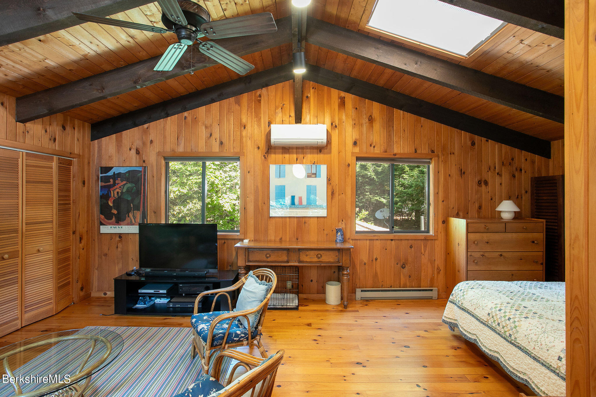 266 Moberg Road Becket, MA 01223 - Photo 24 of 41 a living room with furniture a flat screen tv and a floor to ceiling window
