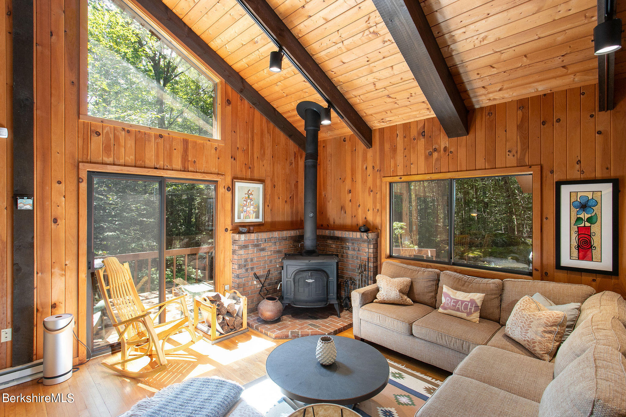 266 Moberg Road Becket, MA 01223 - Photo 5 of 41 a living room with furniture a fireplace and a floor to ceiling window