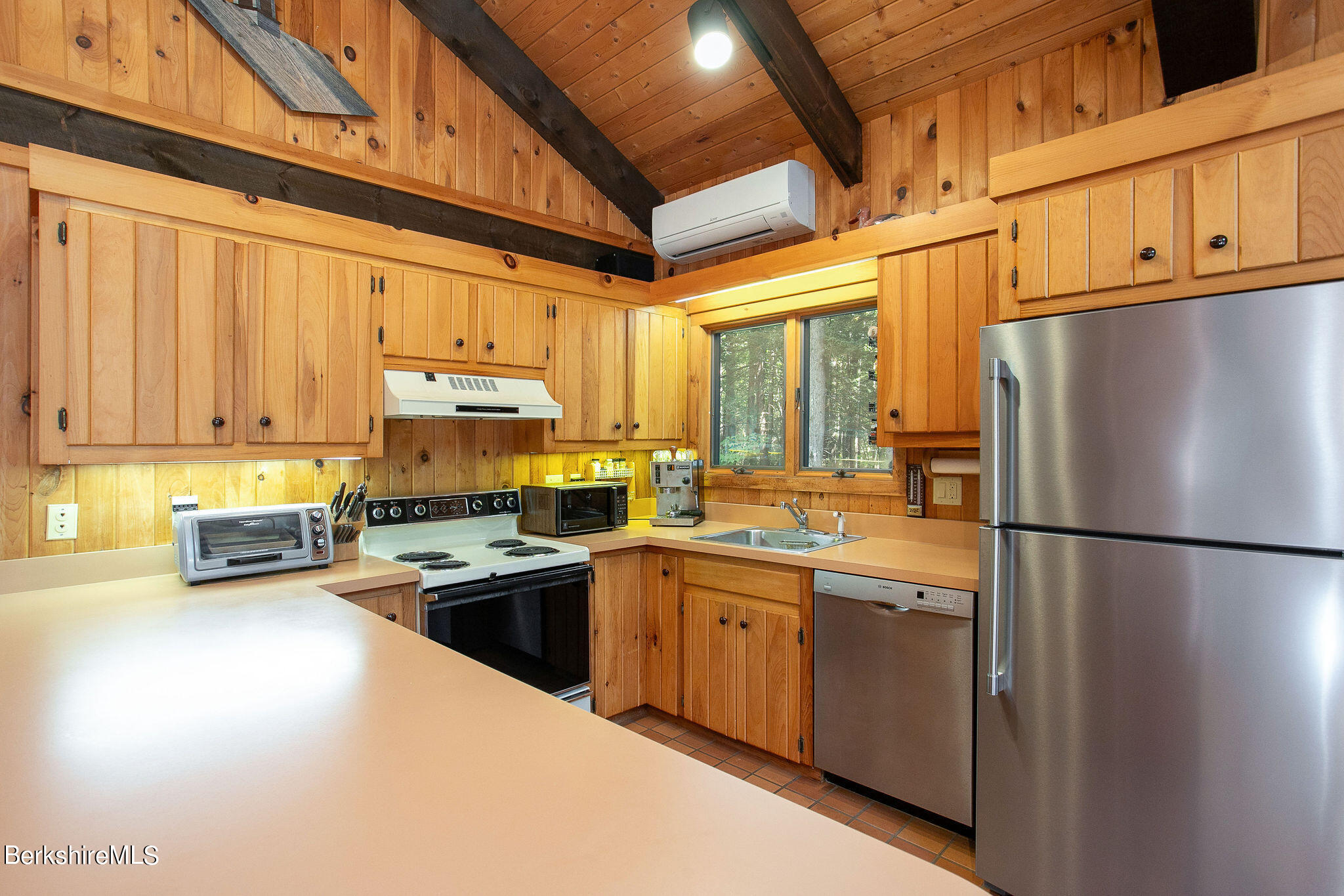 266 Moberg Road Becket, MA 01223 - Photo 8 of 41 a kitchen with a refrigerator a stove a sink dishwasher and cabinets with wooden floor