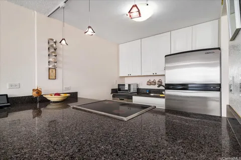 a kitchen that has a sink cabinets and stainless steel appliances