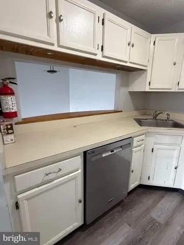a kitchen with white cabinets and white appliances