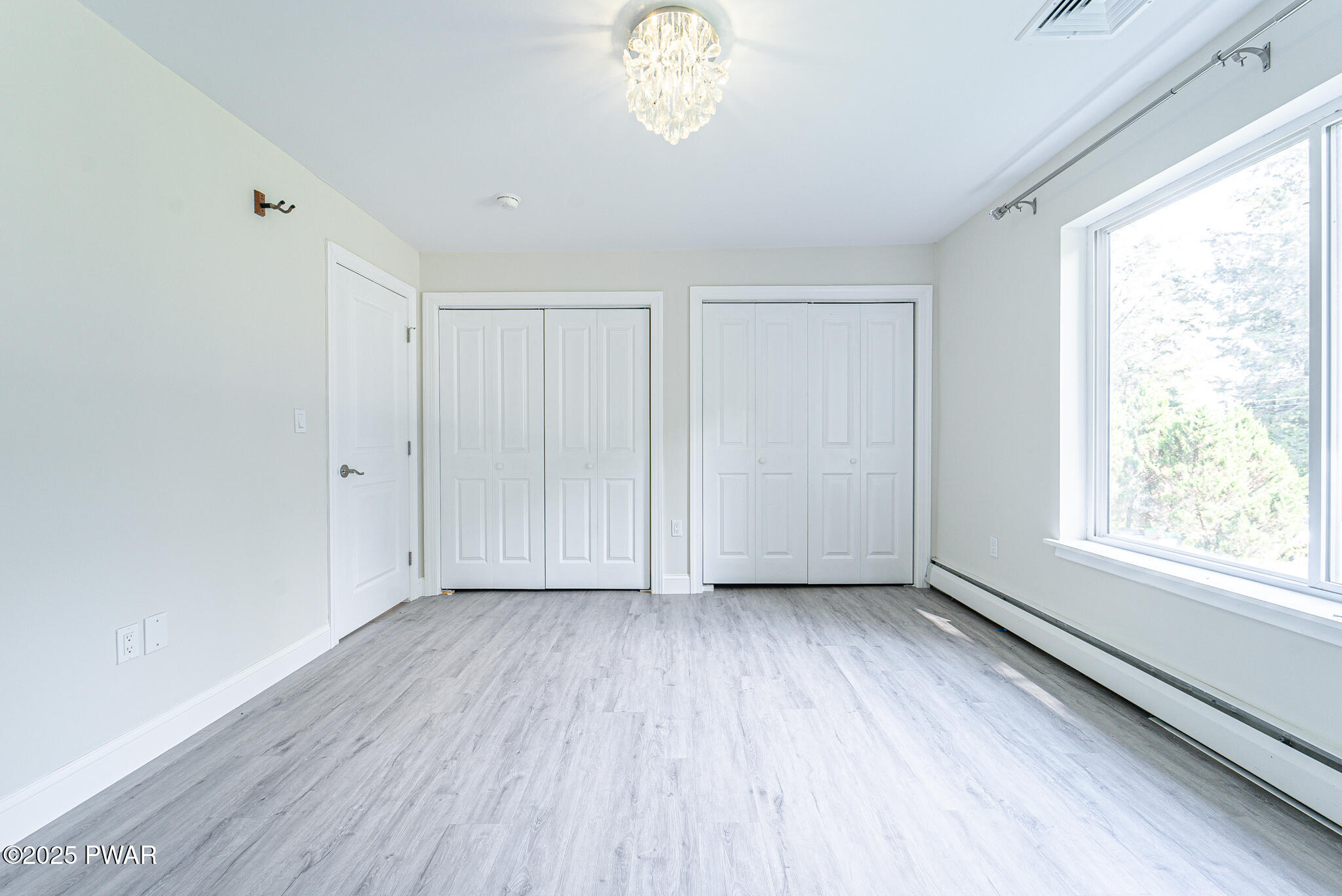 153 Hatton Road Hawley, PA 18428 - Photo 21 of 38 a view of an empty room with a window and wooden floor