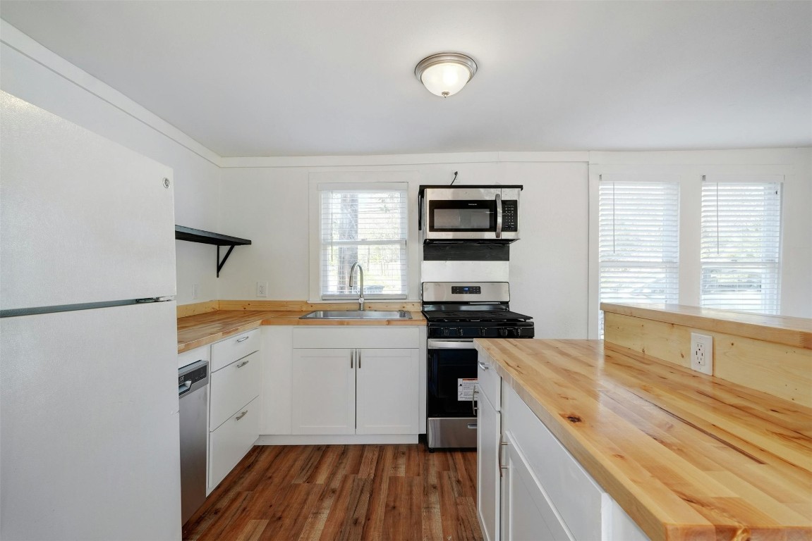 1401 Windsor Road Austin, TX 78703 - Photo 12 of 20 a kitchen with a sink stove top oven and refrigerator