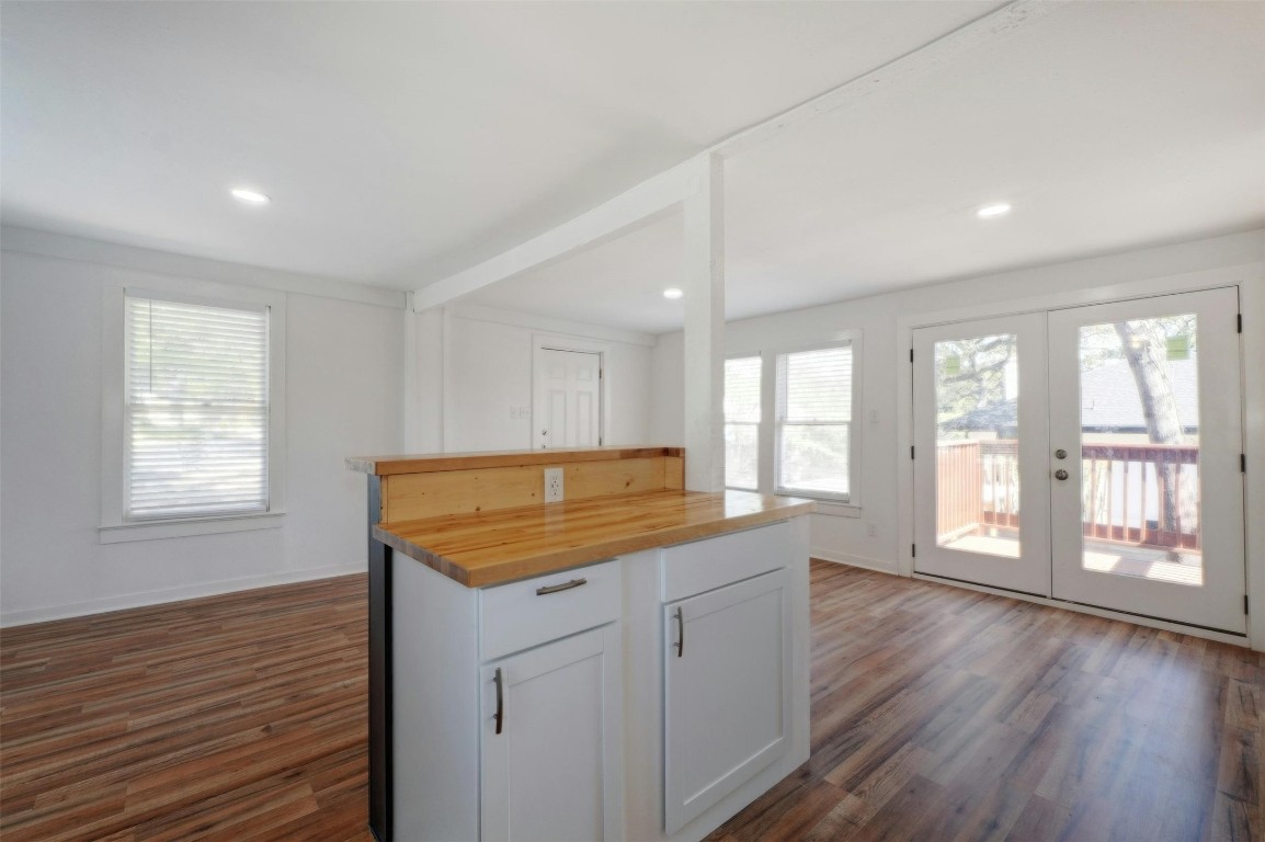 1401 Windsor Road Austin, TX 78703 - Photo 14 of 20 a kitchen with a stove a sink wooden floor and a large window