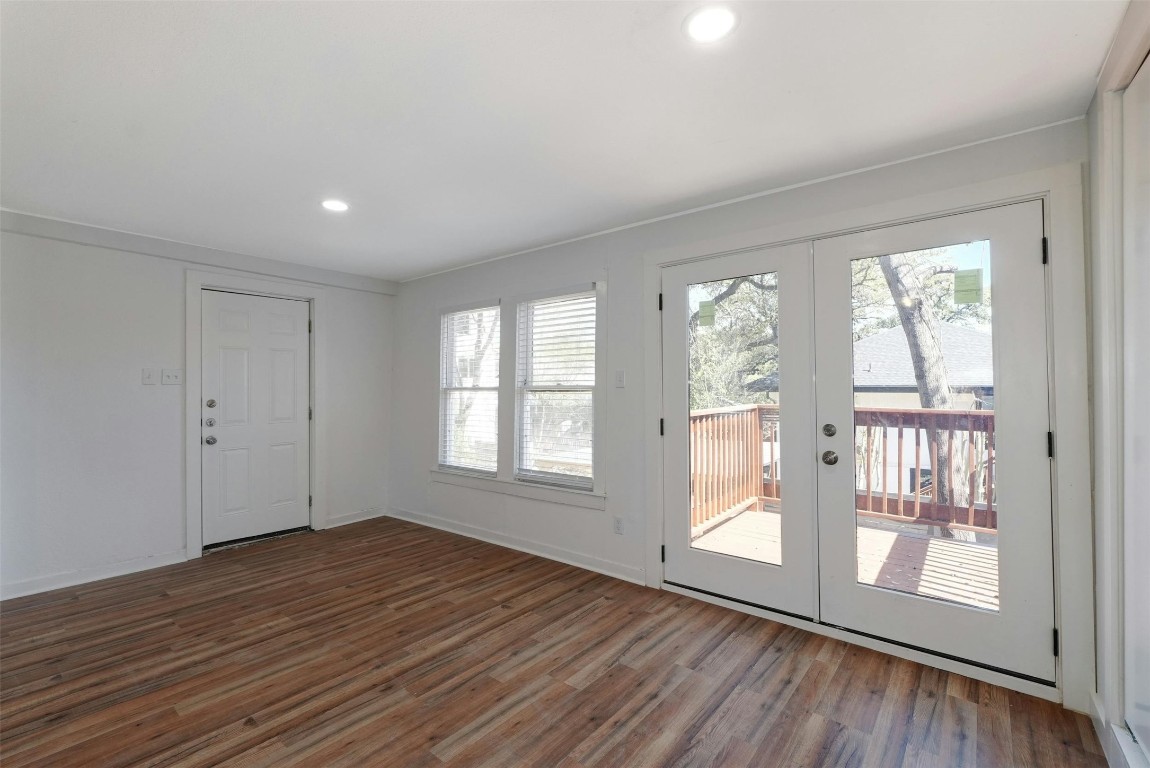 1401 Windsor Road Austin, TX 78703 - Photo 15 of 20 a view of an empty room with wooden floor and a window