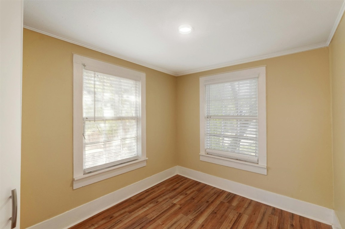 1401 Windsor Road Austin, TX 78703 - Photo 16 of 20 a view of an empty room with wooden floor and a window