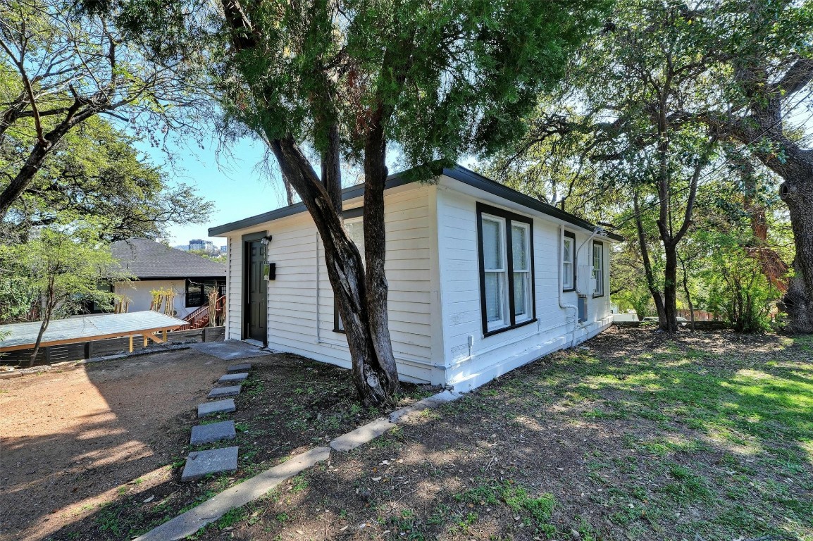1401 Windsor Road Austin, TX 78703 - Photo 5 of 20 a view of a house with a large tree and wooden fence