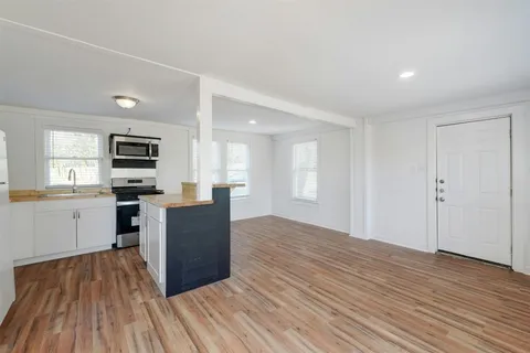 a view of kitchen with microwave and cabinets