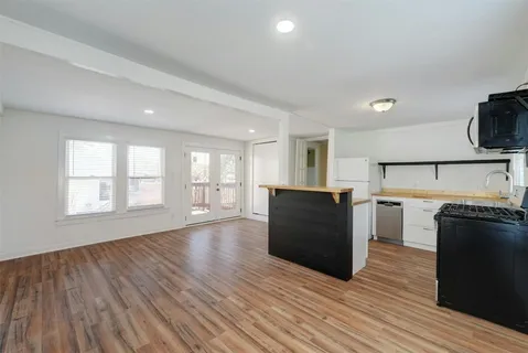 a kitchen with a refrigerator and a stove top oven