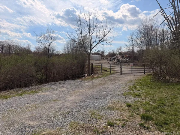 a view of outdoor space with wooden fence and trees