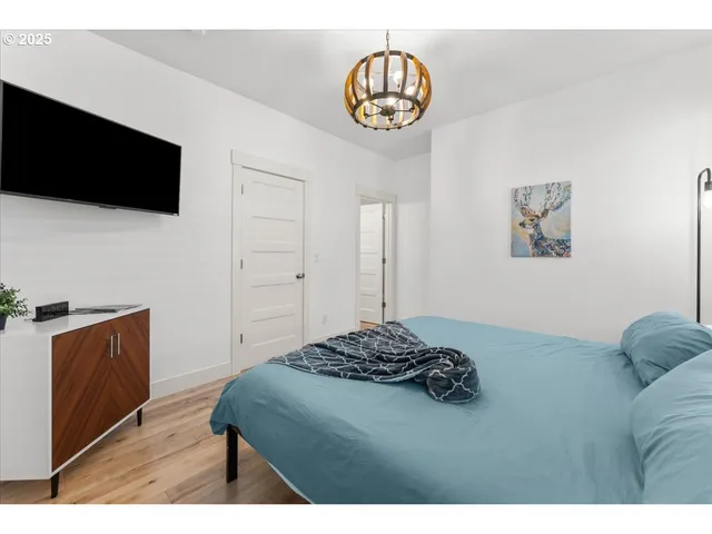 a bedroom with a bed and a television