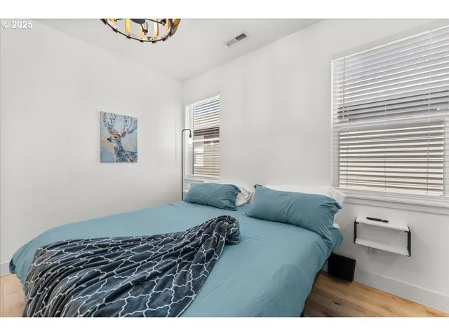 a bedroom with a bed with window