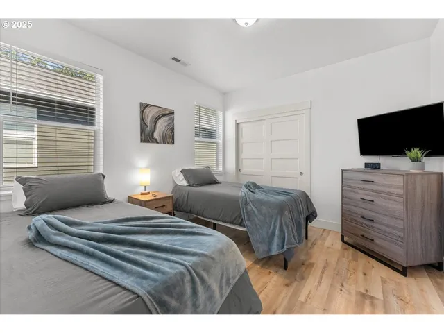 a bedroom with a bed and a television