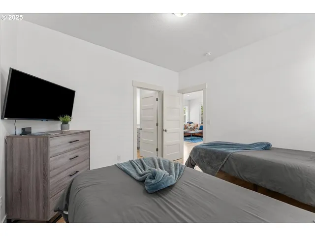 a bedroom with a bed and flat screen tv