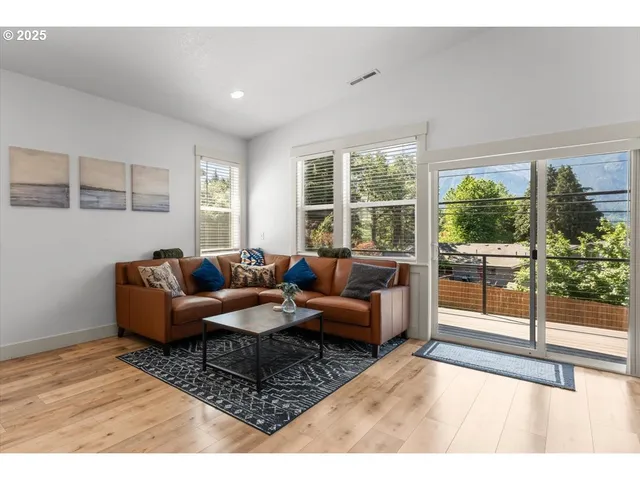 a living room with furniture and a floor to ceiling window