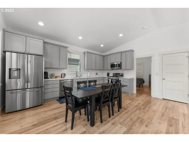 a kitchen with kitchen island wooden cabinets and stainless steel appliances