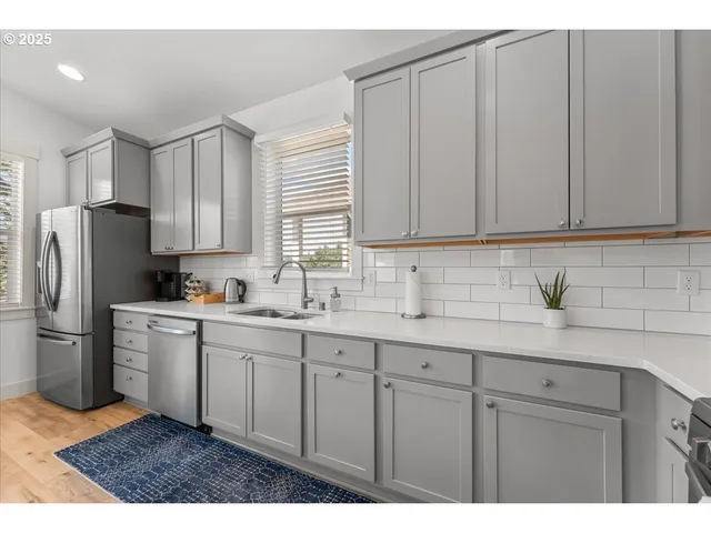 a kitchen with appliances cabinets and a sink